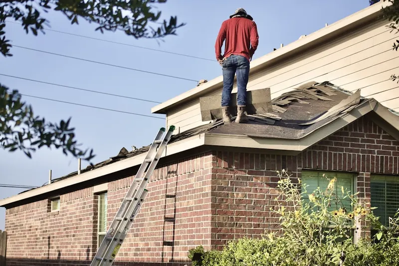 Professional roofer working on a residential roof in Five Points District